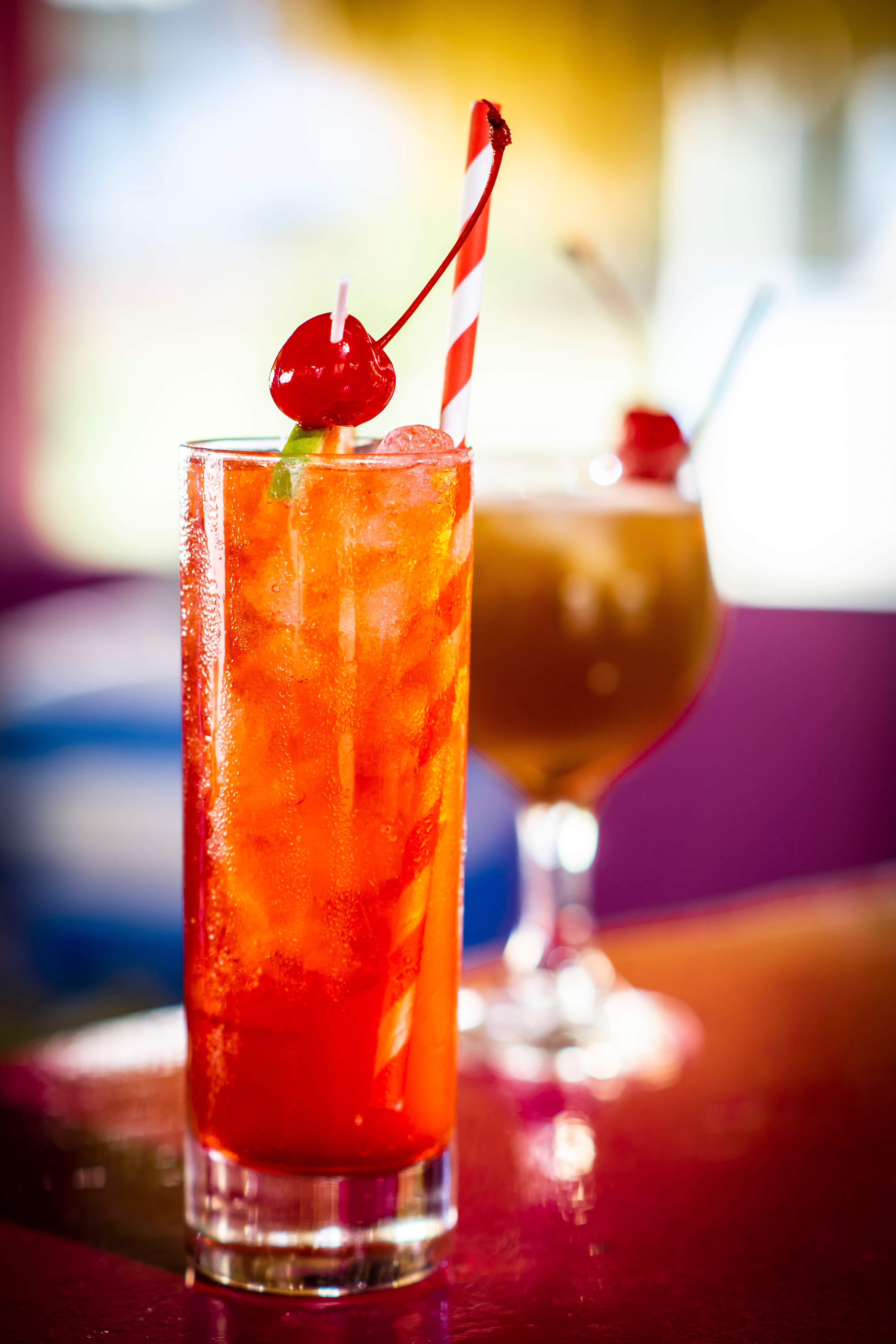 Tropical cocktails with cherry garnishes at Beyond Sunset Bar
