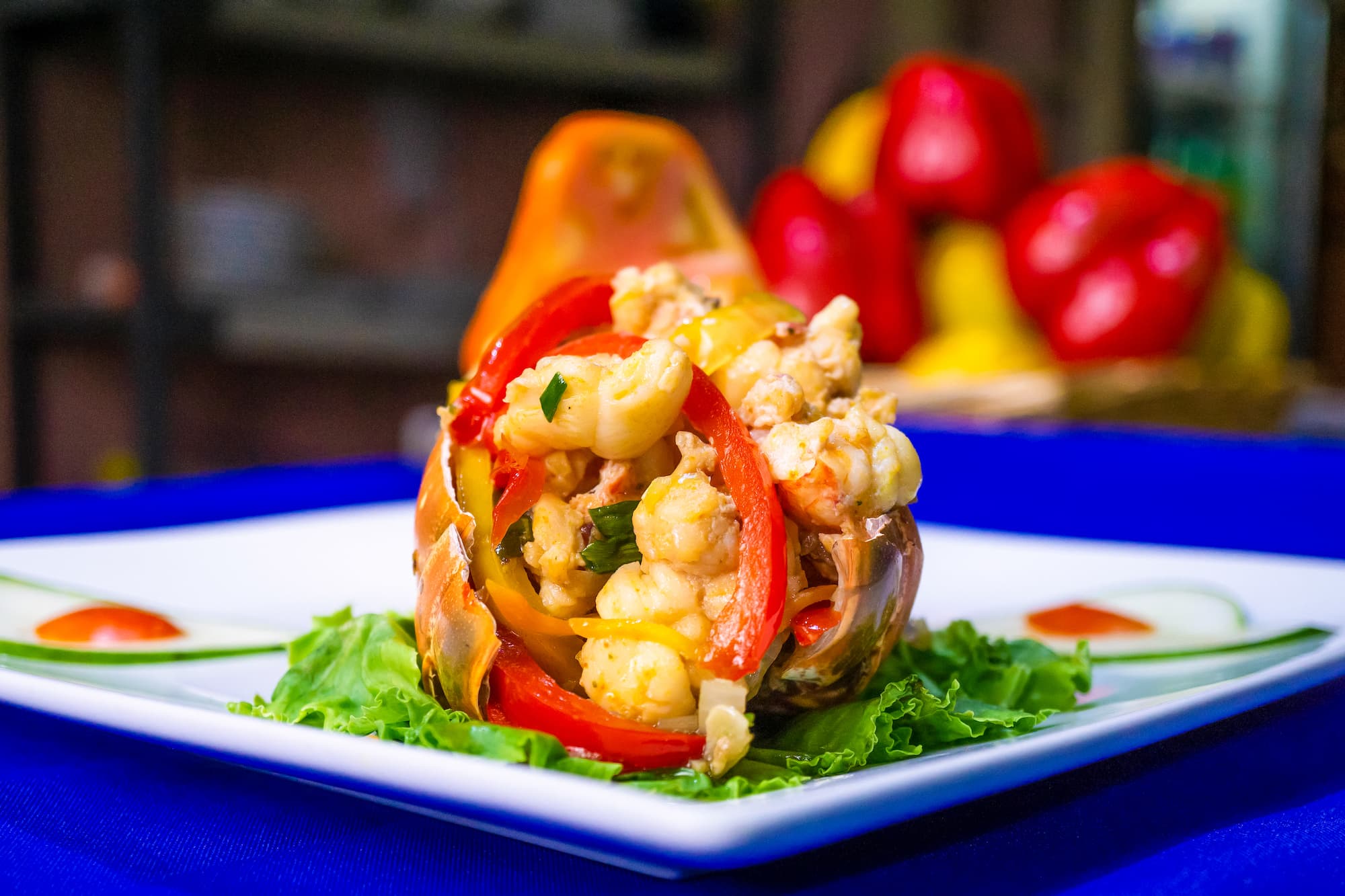 Seafood and peppers served in a pineapple with fresh greens